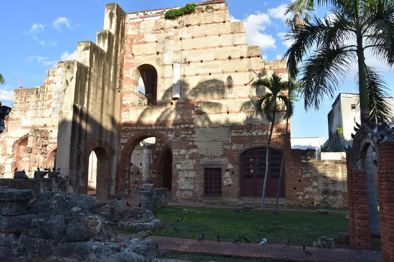 The floodlit ruined walls and arches of a colonial monastery in the old town