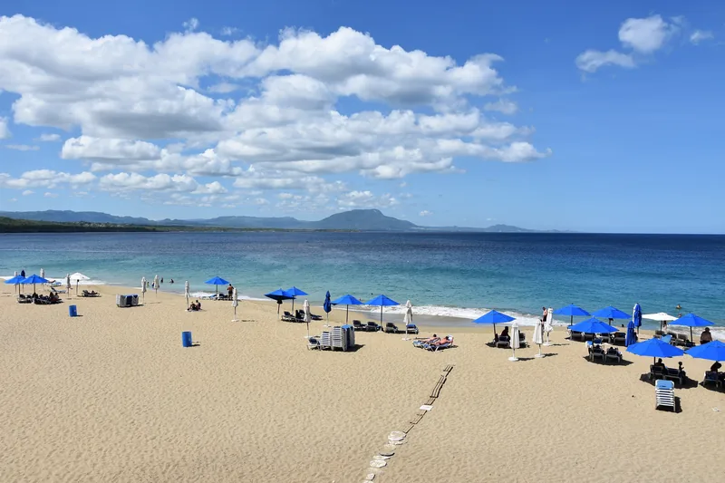 The sheltered golden-sand horseshoe of Playa Sosúa, calm and shallow enough to snorkel straight off the beach